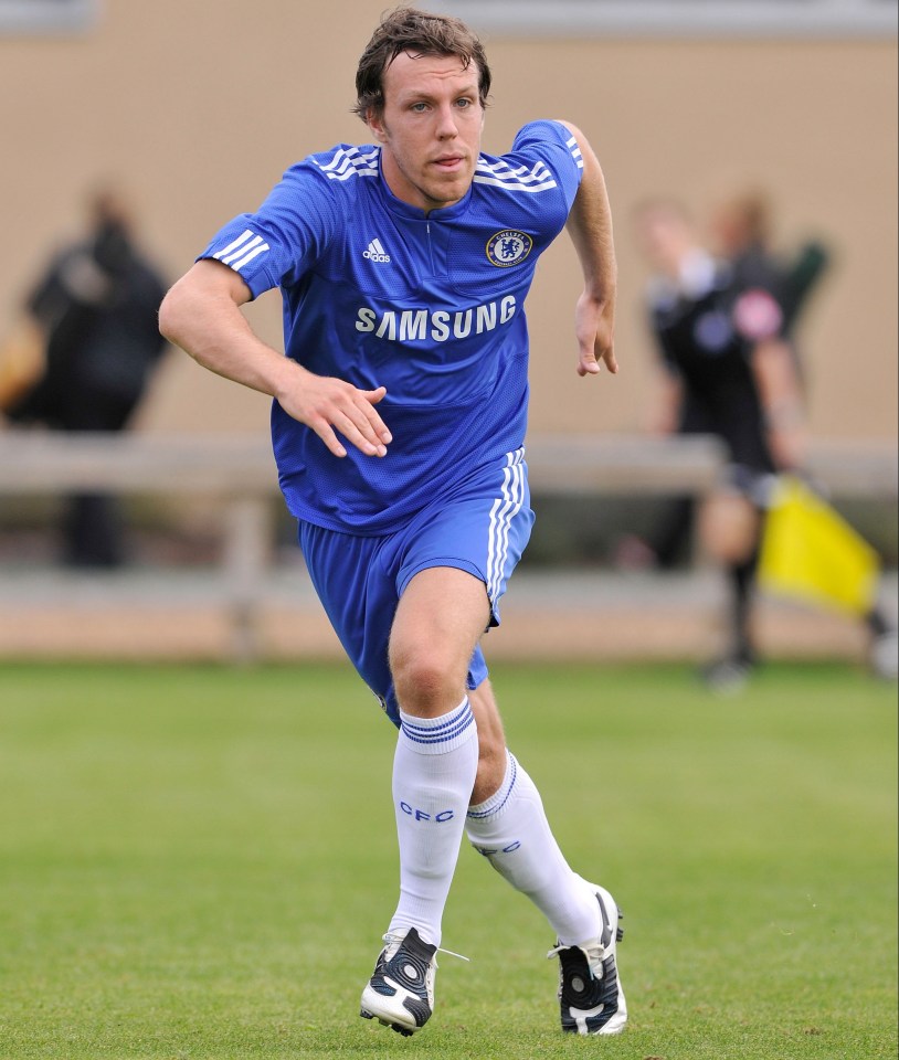 a soccer player wearing a blue samsung jersey is running on the field