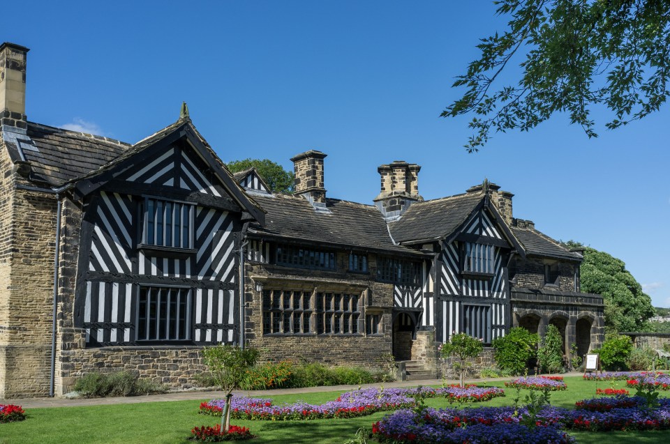 a black and white house with a blue sky in the background