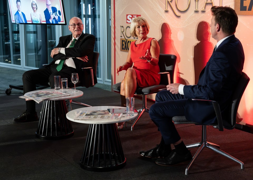 three people sit in front of a sign that says royal exclusive