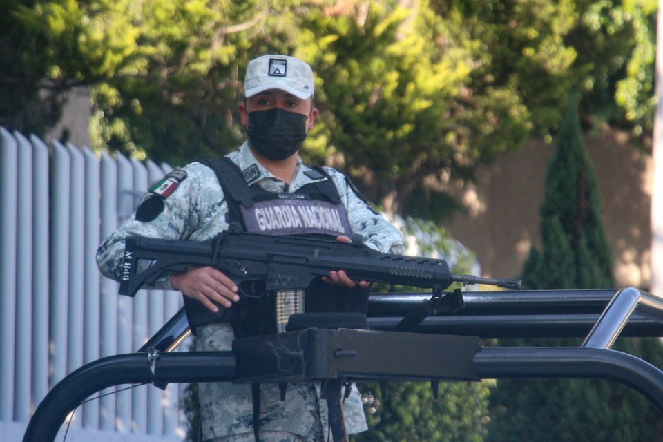 Federal forces take security measures outside the Special Prosecutor’s Office before the departure of a convoy carrying Ovidio Guzman