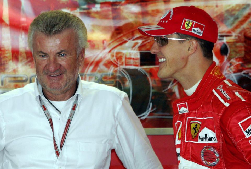 a man wearing a red marlboro hat talks to another man