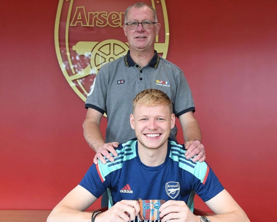 a man stands behind a young man wearing an adidas shirt