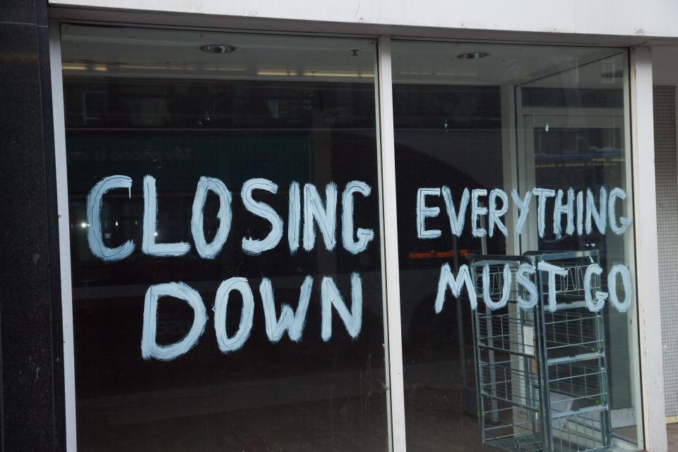 a store front with the words closing everything down painted on it