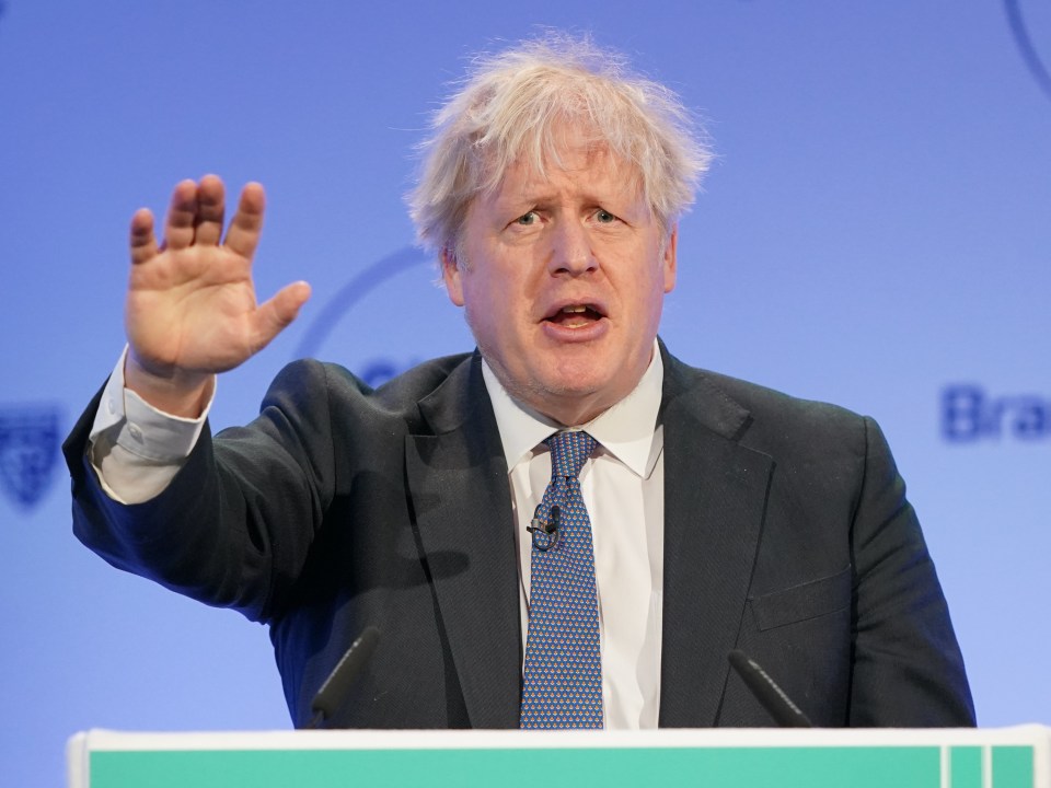 a man in a suit and tie is giving a speech