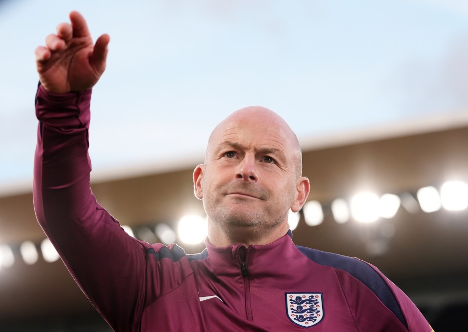 a bald man wearing a maroon jacket with england on it