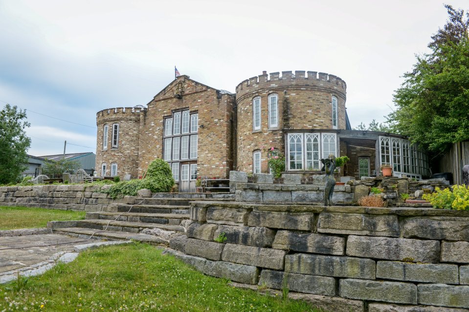 a large brick building with a flag on top of it