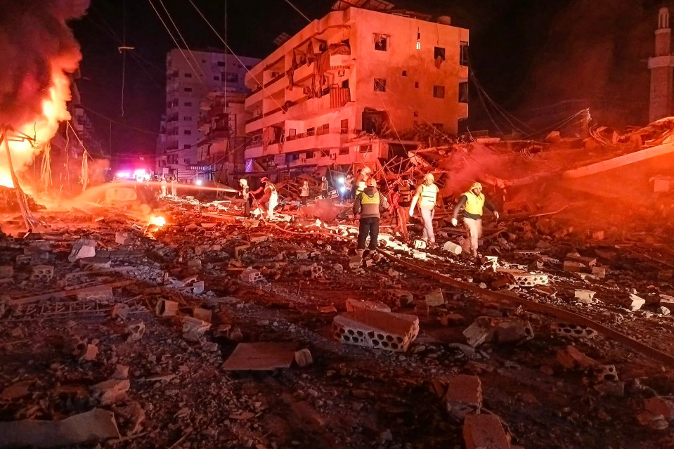 First responders battle flames following an Israeli airstrike in the southern Lebanese village of Abbasiyeh