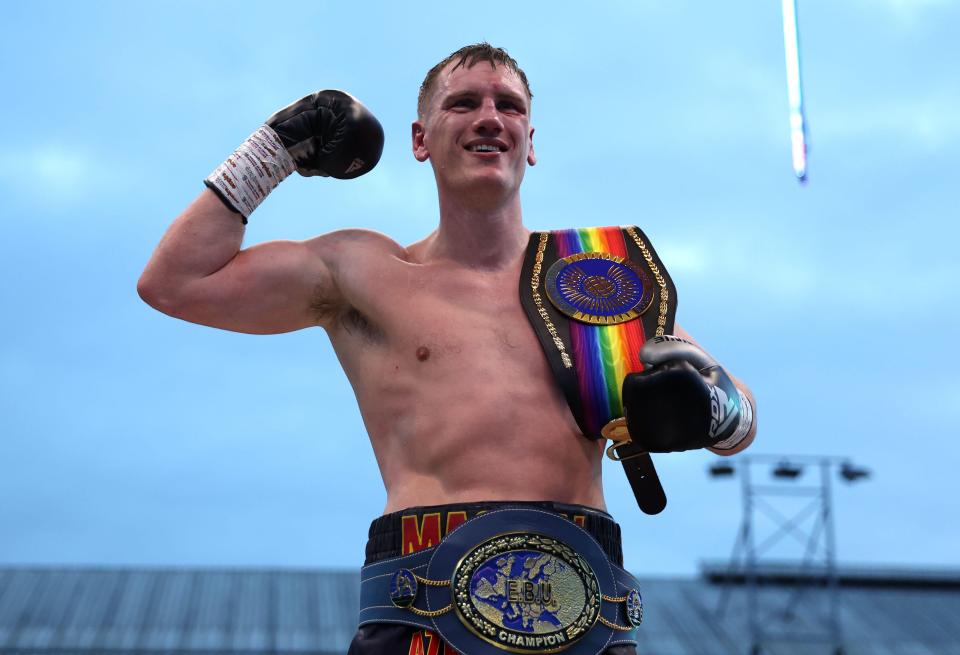 a boxer wearing a belt that says ' world champion ' on it