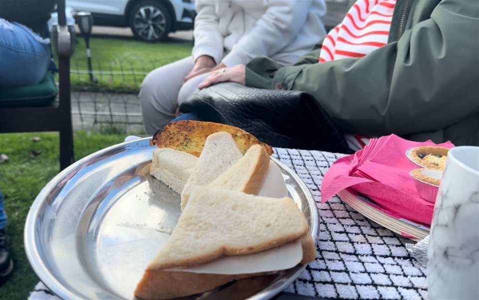 Locals share food at the communal meeting place in Hopeville Avenue