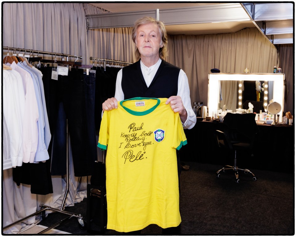 Sir Paul McCartney with his signed Pele shirt