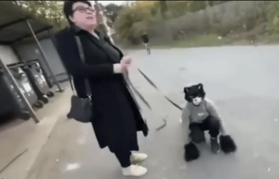 Another teenager dressed up as a black cat and tied to a leash was seen walking on all fours on a public street