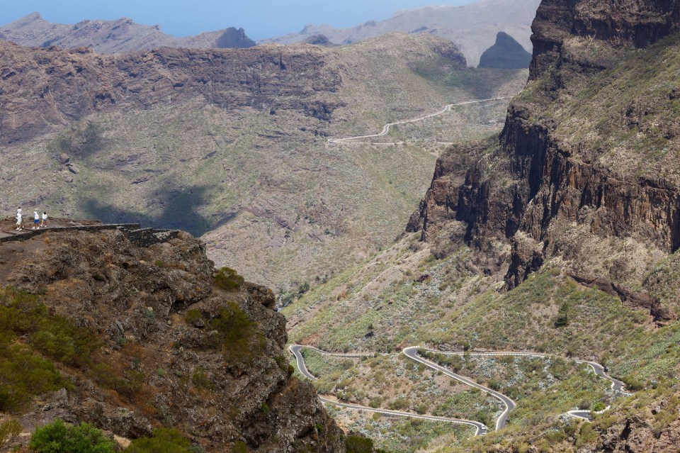 a mountain landscape with a road going through it