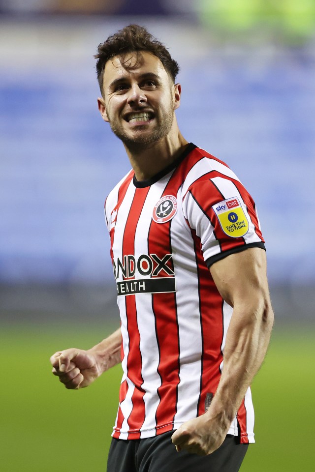 a man wearing a red and white striped shirt with the word andox on it