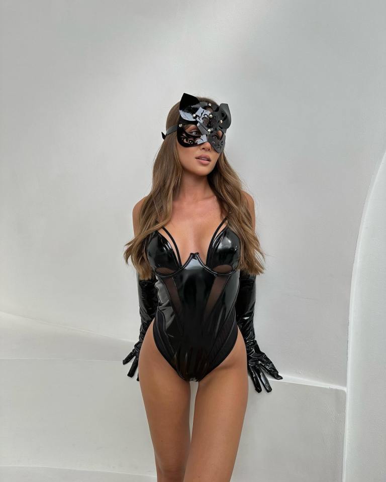 a woman is wearing a cat mask and gloves