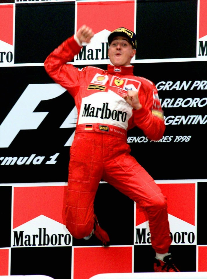 a man in a red marlboro suit jumps in the air