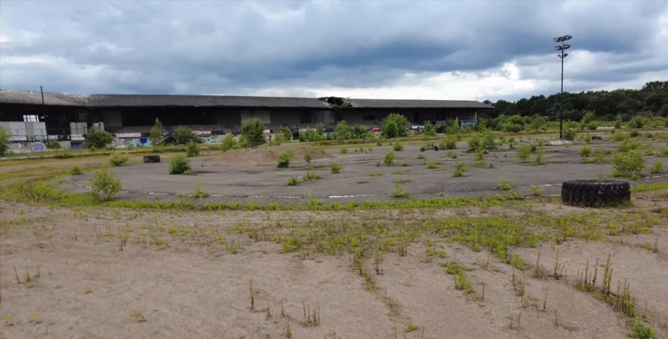 The track has been left overgrown and littered with objects