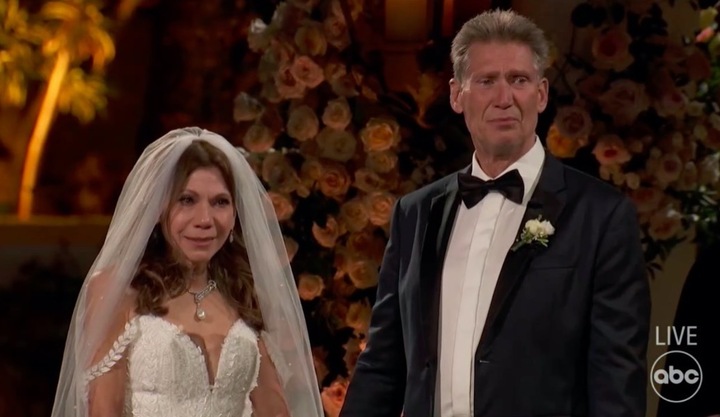 a bride and groom are standing in front of a live abc sign