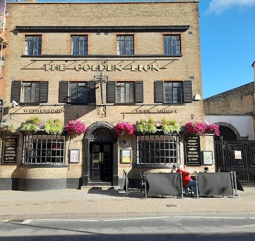 Wetherspoons is being sued for more than £200,000 after a drinker fell to his death from a second-floor window, pictured the Golden Lion in Cambs