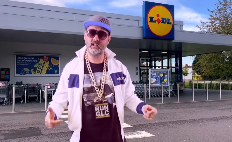 a man standing in front of a lidl store