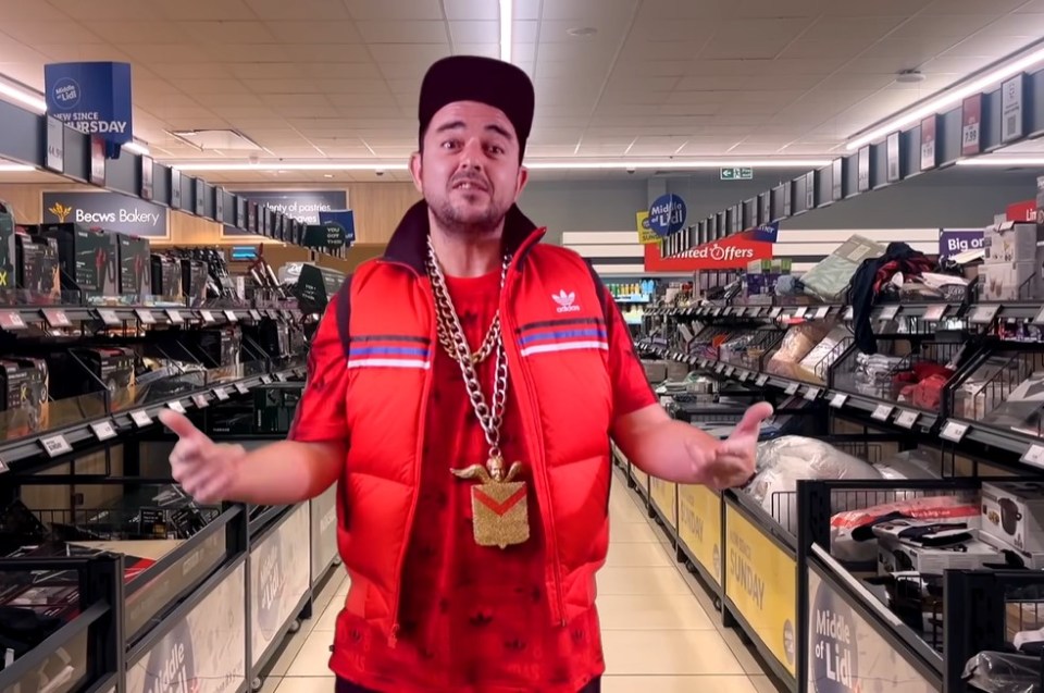 a man in a red adidas vest stands in a store aisle