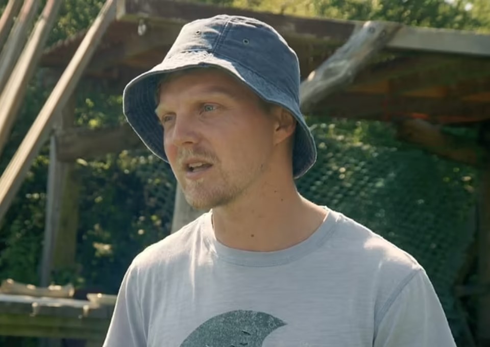 a man wearing a blue hat and a grey shirt