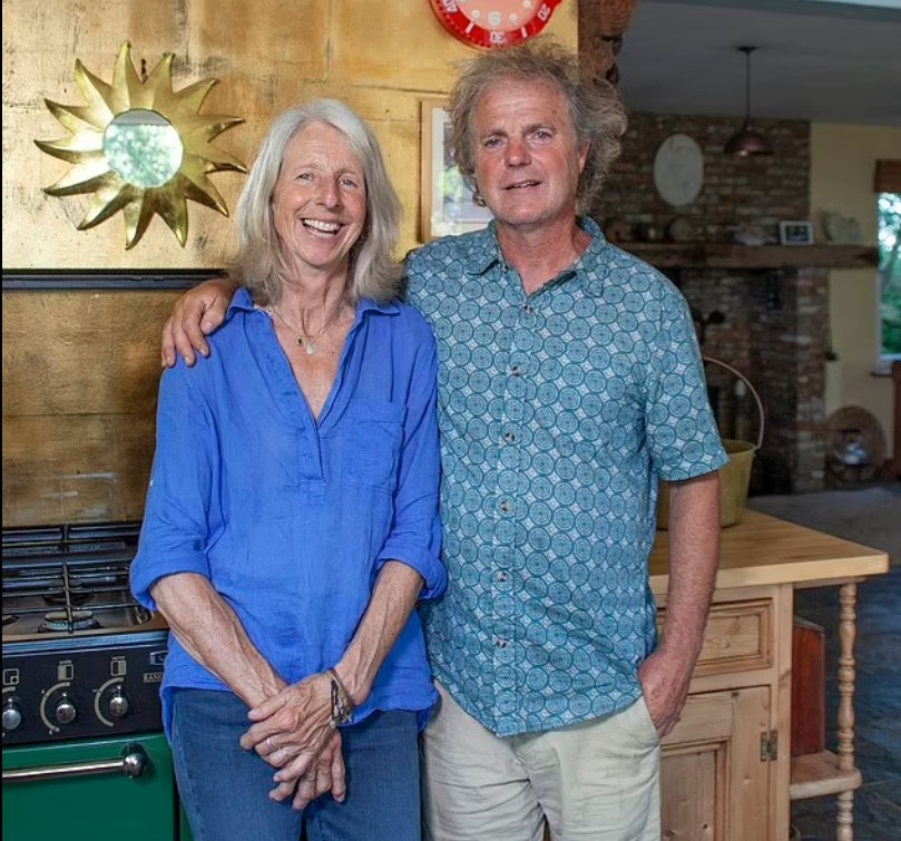 a man and a woman standing next to each other in a kitchen