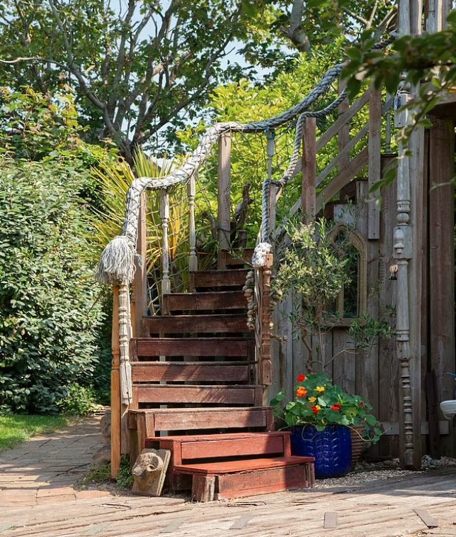 a set of wooden stairs with a rope railing