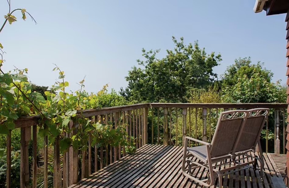 a wooden deck with a rocking chair on it