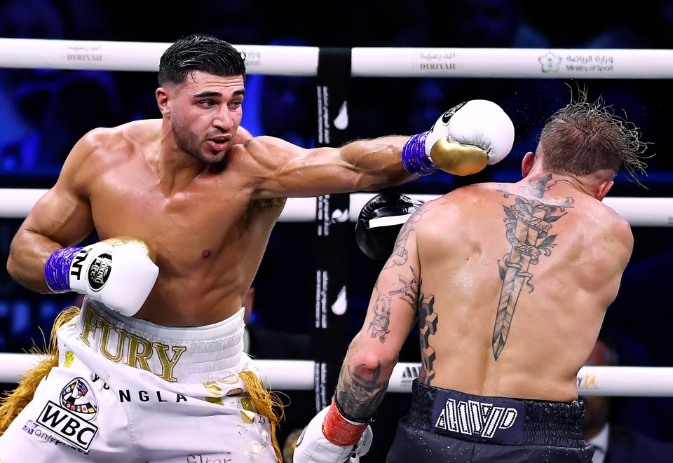 two boxers in a ring one of whom has the word fury on his shorts