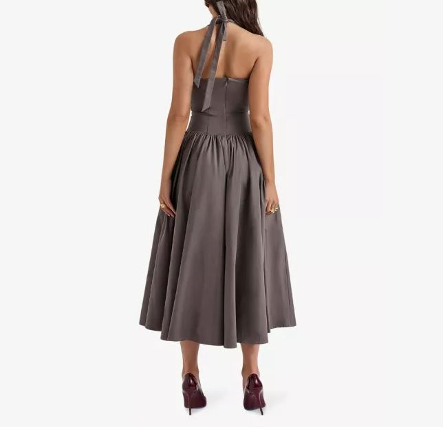 the back of a woman wearing a grey halter dress and burgundy heels .