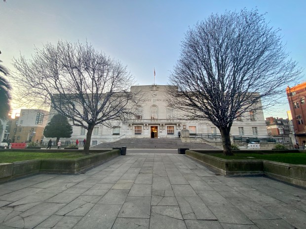 a large white building with a clock on the top of it