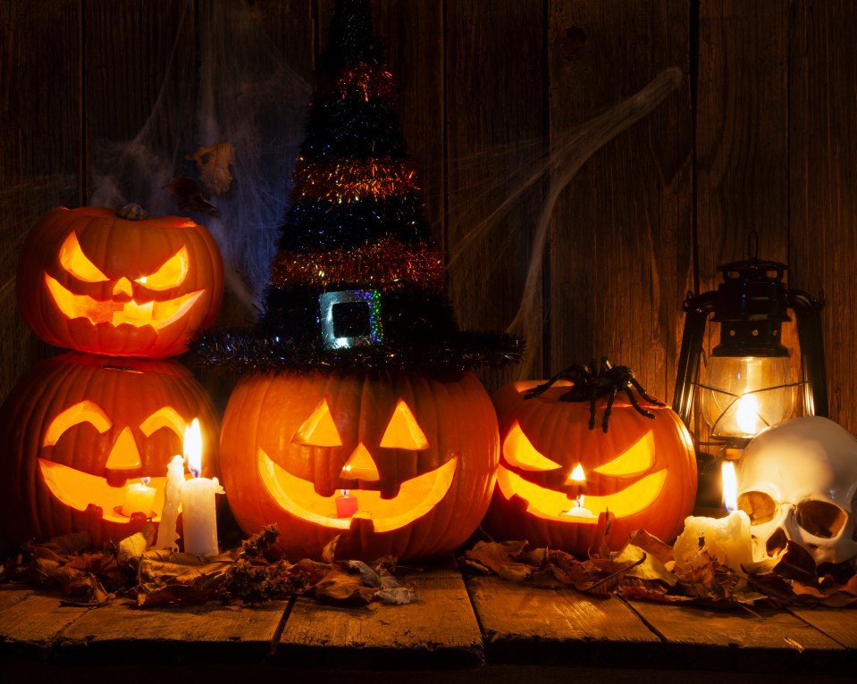 halloween pumpkins with candles and a witch hat