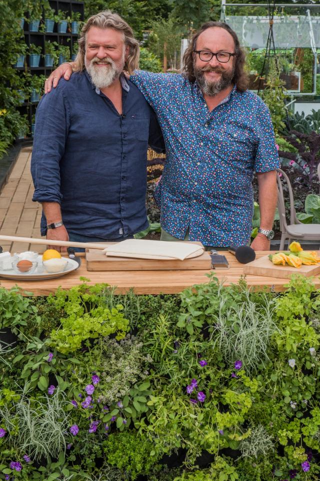 two men standing next to each other with their arms around each other