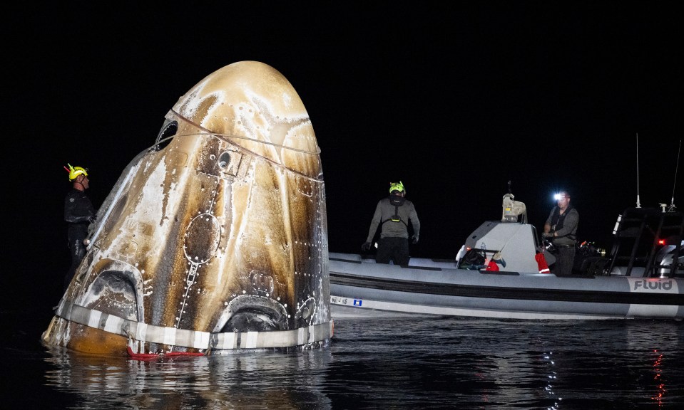 A SpaceX capsule looking like a giant whale is recovered from the sea yesterday