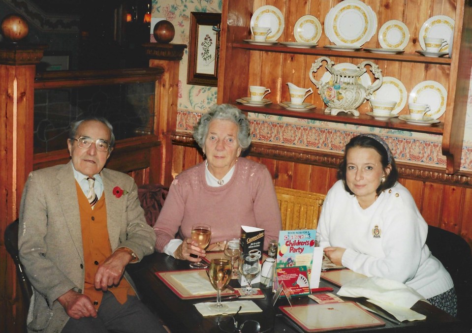 three people sitting at a table with a children 's party book in front of them