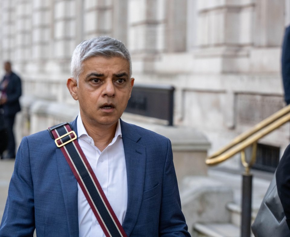 a man in a suit has a striped strap around his shoulder