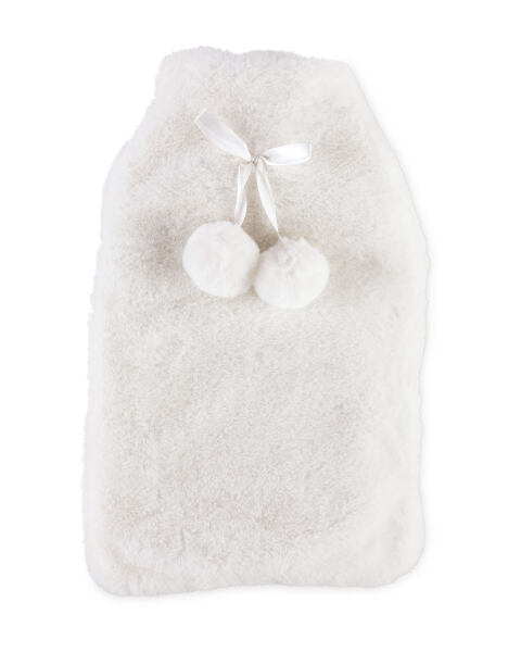 a white furry hot water bottle with two white pom poms attached to it .