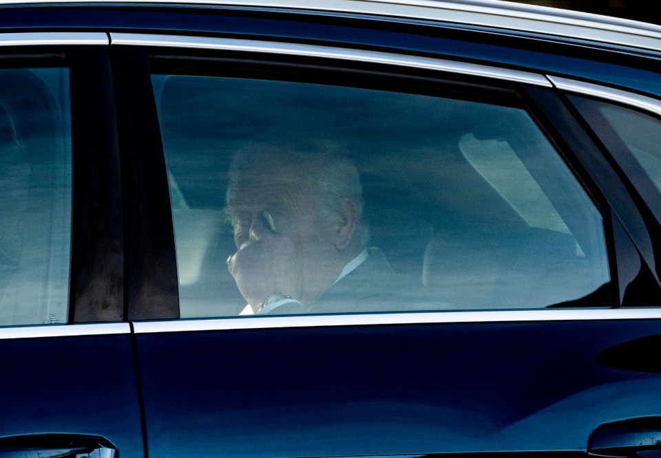 a man in a suit is sitting in a blue car