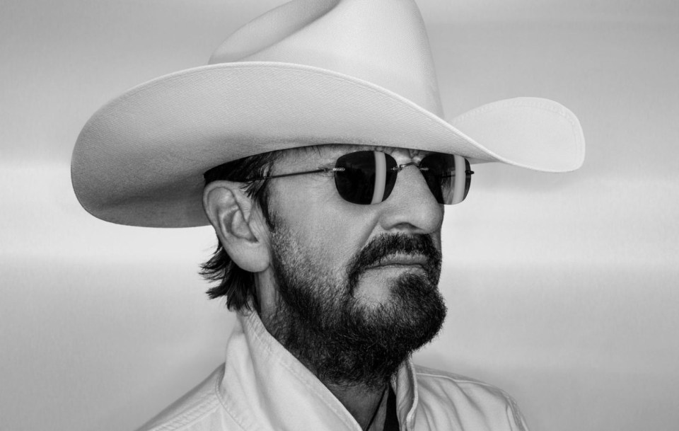 a man with a beard wearing a cowboy hat and sunglasses