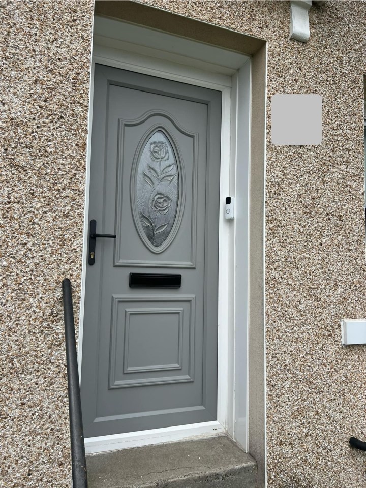 a gray door with a floral design on it