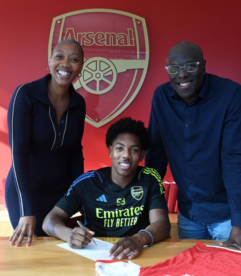 a man wearing a black emirates fly better jersey