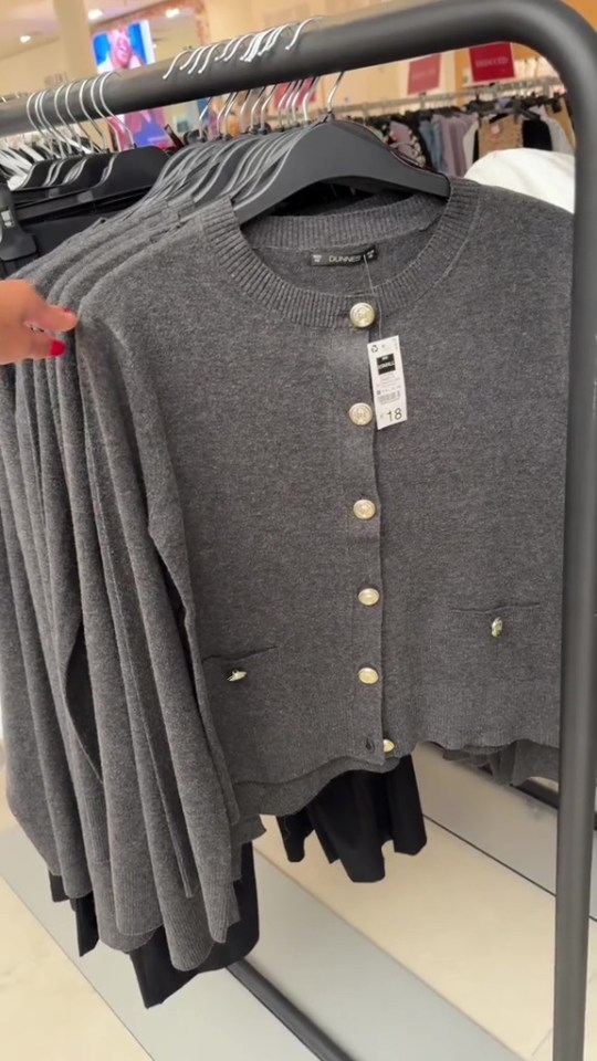 a gray cardigan with gold buttons and a tag that says 18