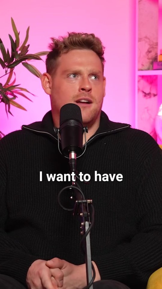 a man sitting in front of a microphone that says i want to have