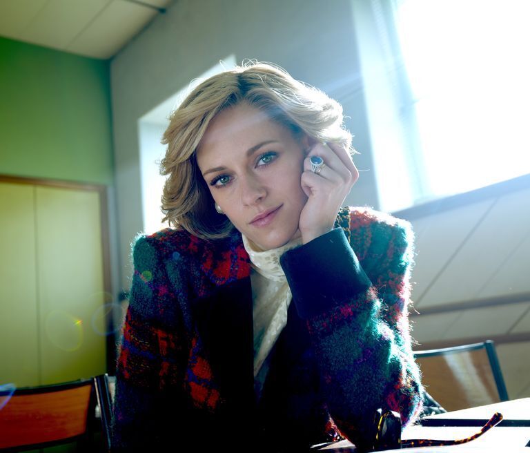 a woman with a ring on her finger looks at the camera