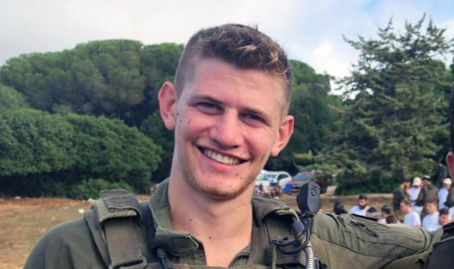 a young man in a military uniform is smiling for the camera .