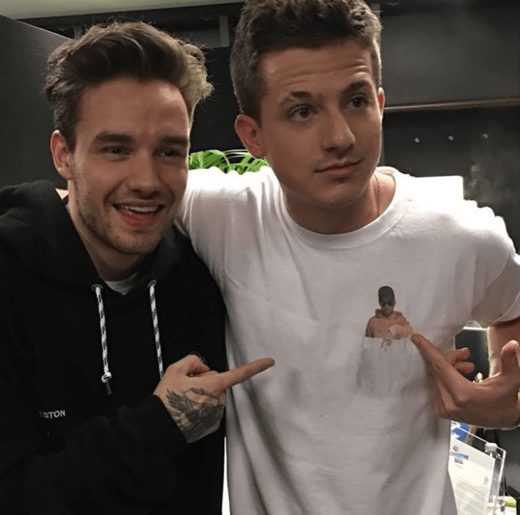 a man wearing a sweatshirt that says boston stands next to another man