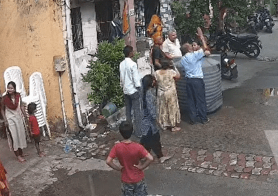 A huge crowd of worried neighbours rushed to the woman's side as they all shouted up at the terrace above