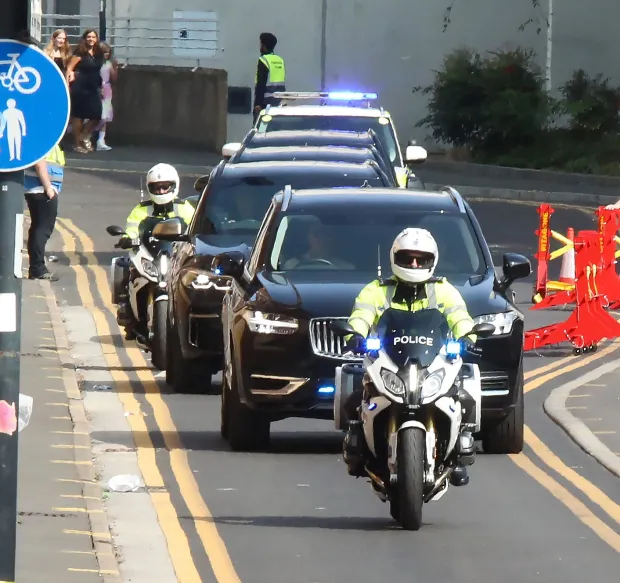 a row of police cars and motorcycles on a street