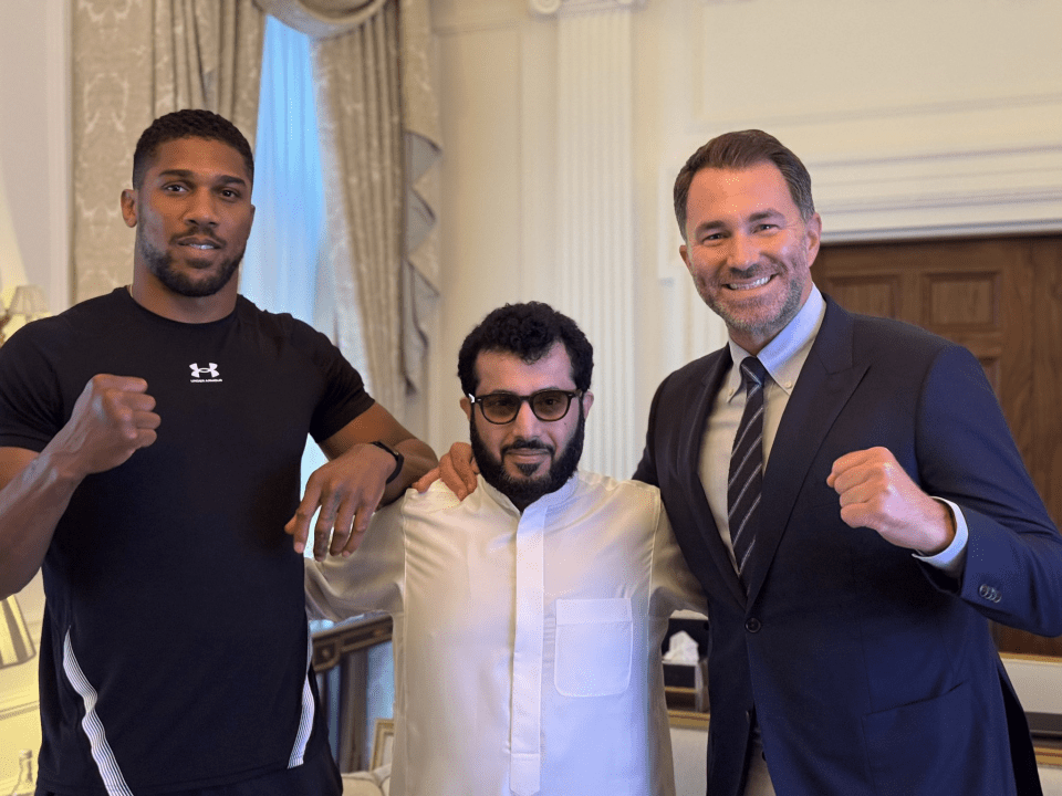 a man wearing an under armour shirt poses with two other men