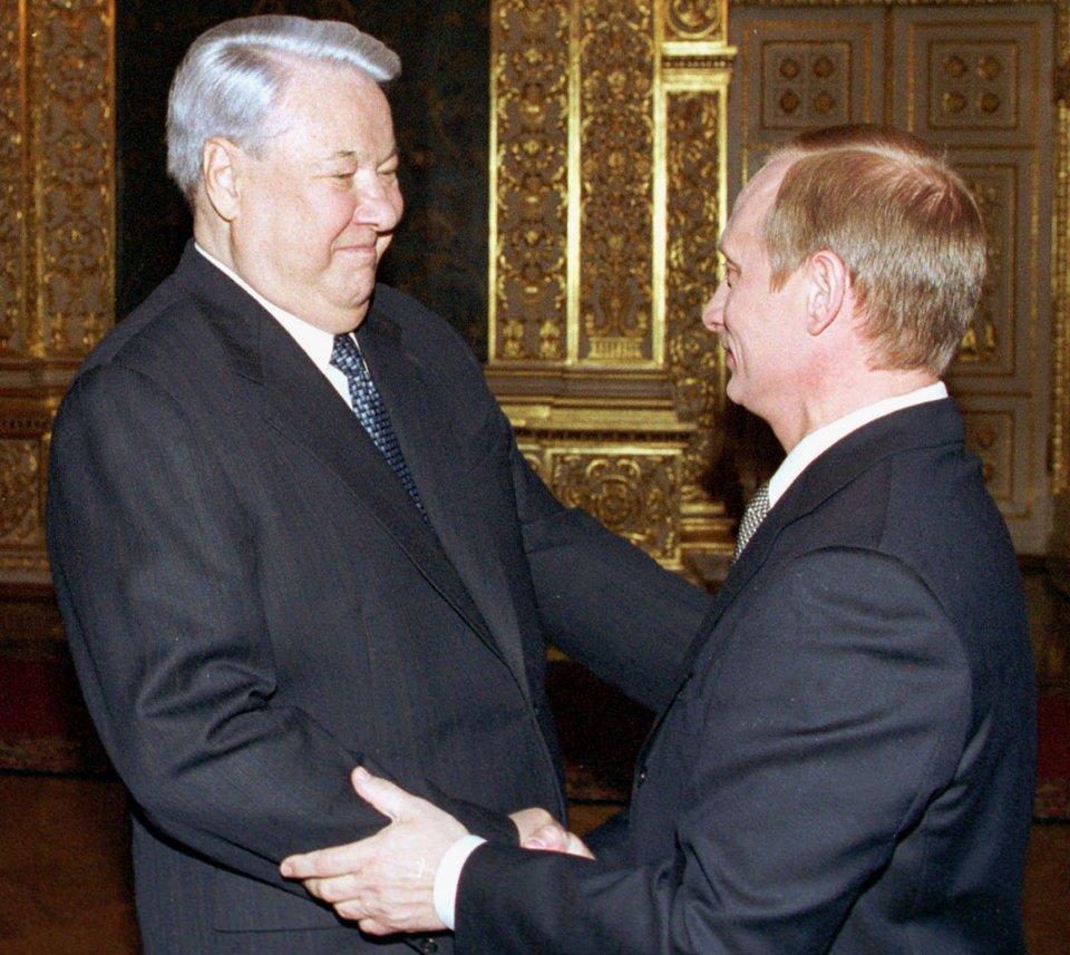 Petrov's former boss and first Russian president Boris Yeltsin shaking hands with a young Putin